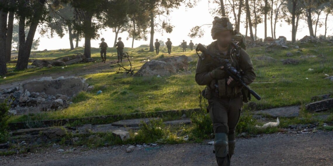 a group of people walking on a path with trees and grass